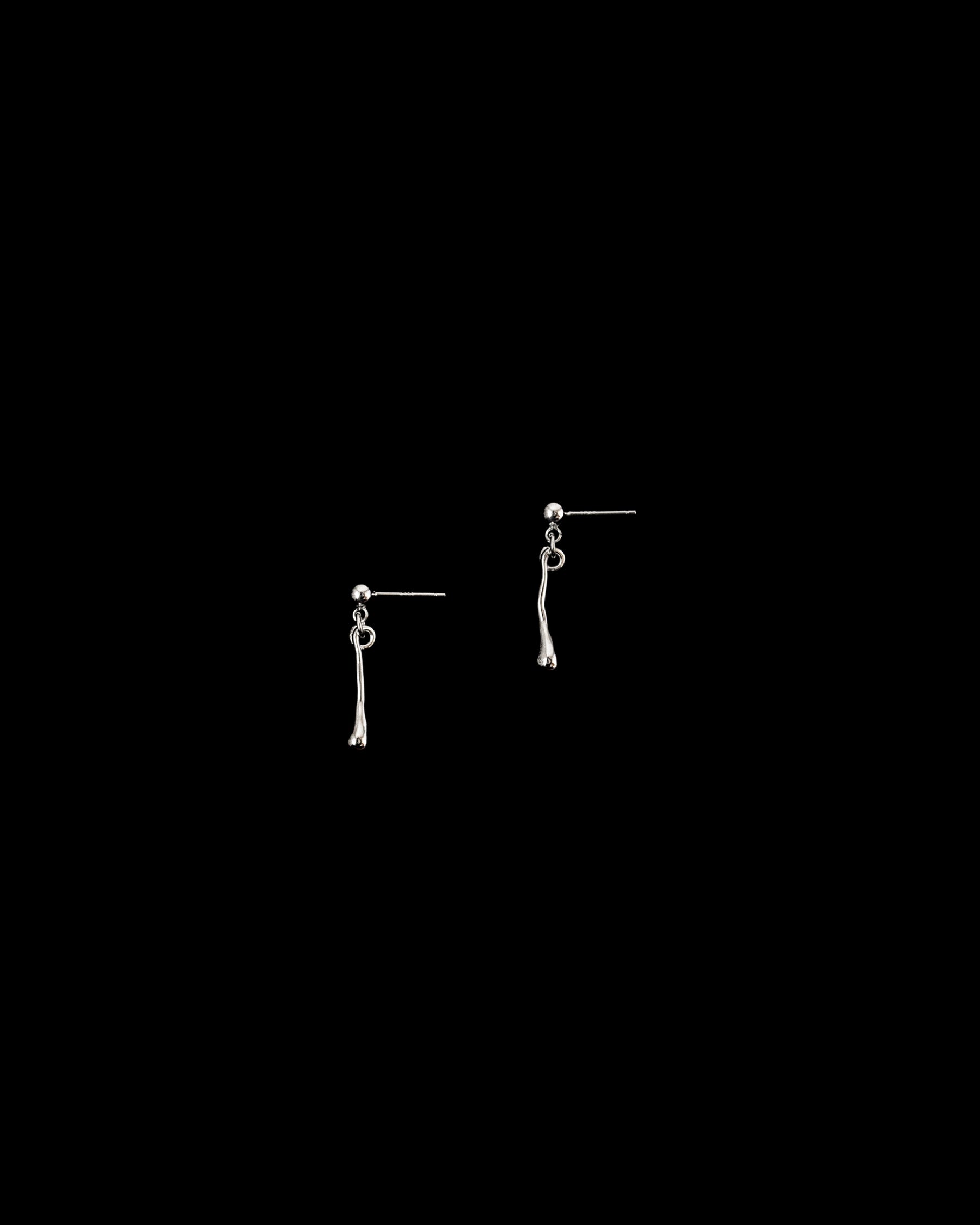 Silver fluid drop earrings, displayed against a black background.