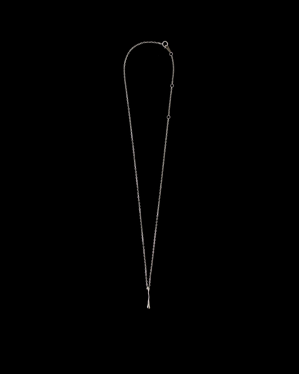 Silver fluid drop pendant necklace on a black background