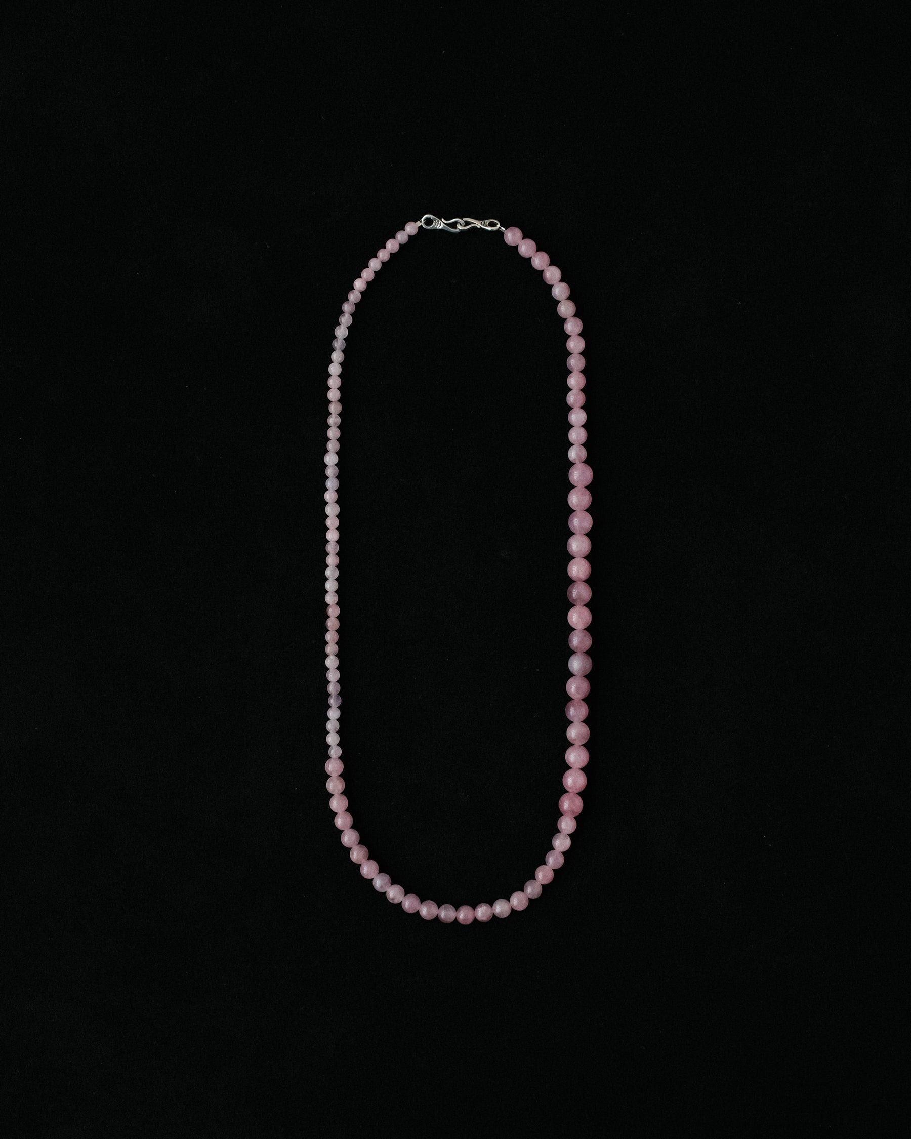 Necklace with natural rose quartz on a black background