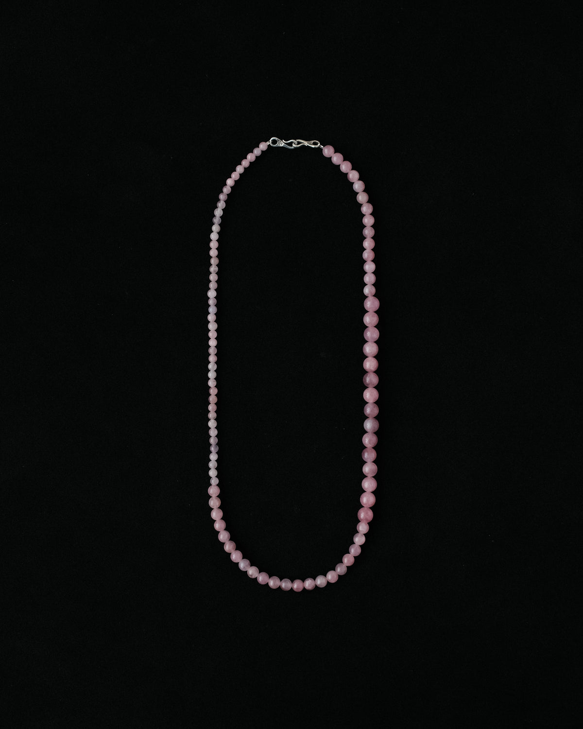 Necklace with natural rose quartz on a black background