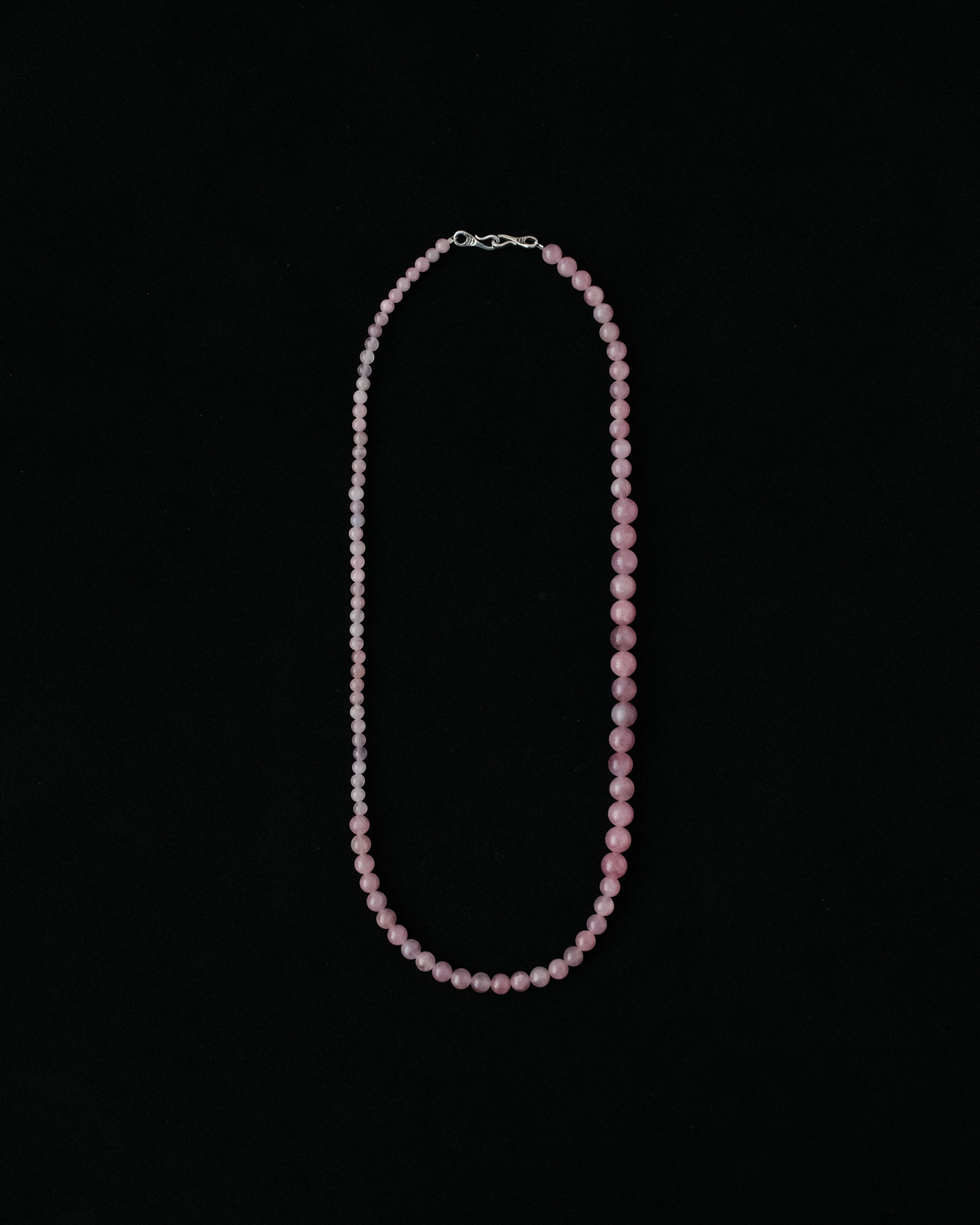 Necklace with natural rose quartz on a black background