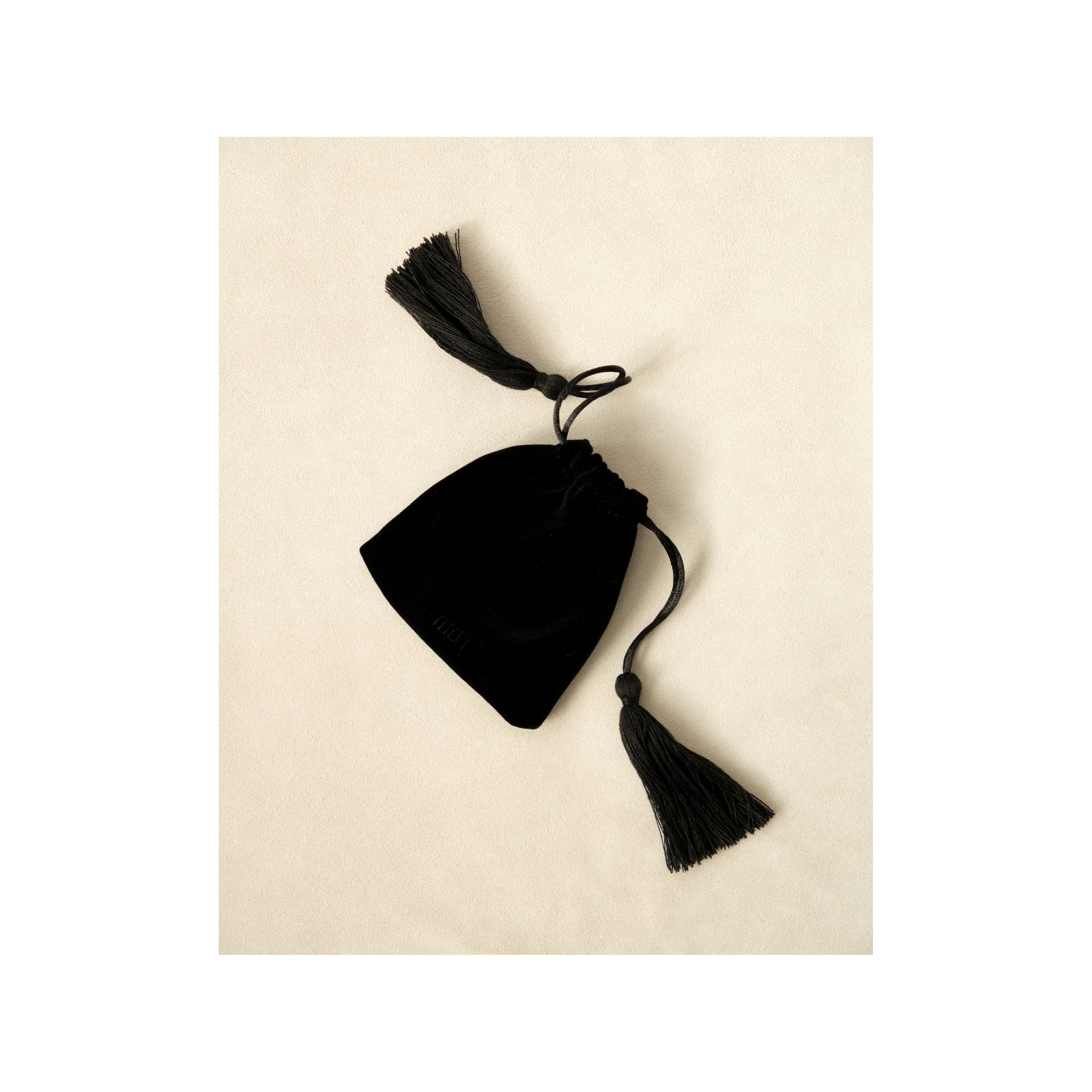 MYJN Atelier black velvet drawstring pouch with tassel accents
