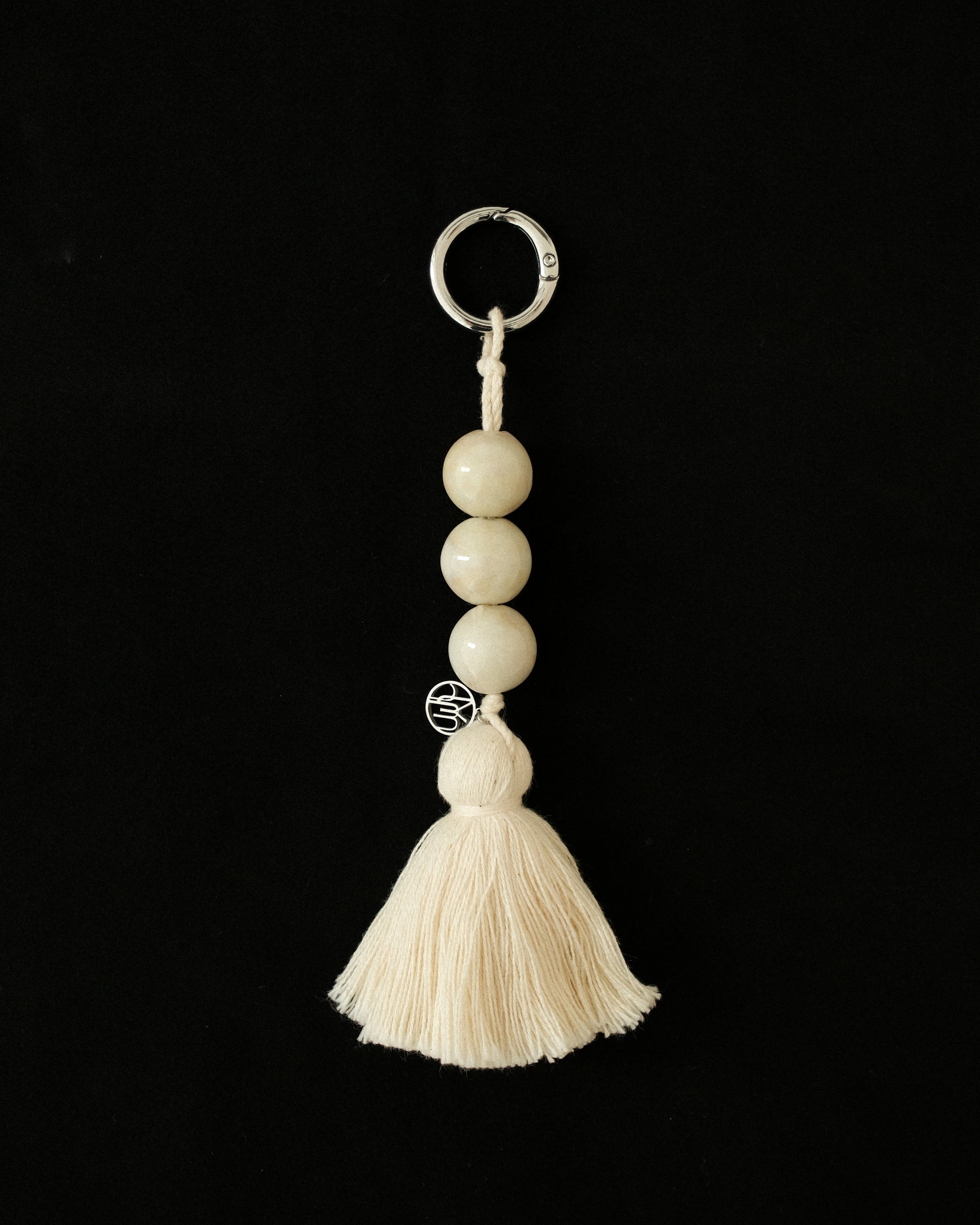 MYJN keychain with beads and tassel on a black background